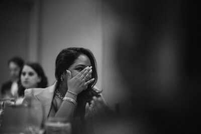 A black and white photo of a woman shedding a tear.