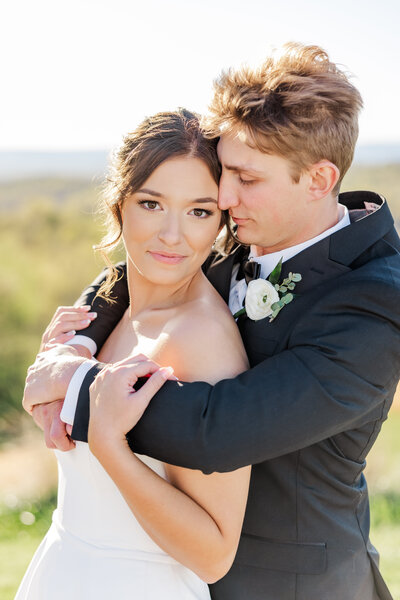 a man embracing his bride on their wedding day