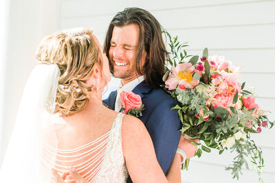 bride and groom laughing together