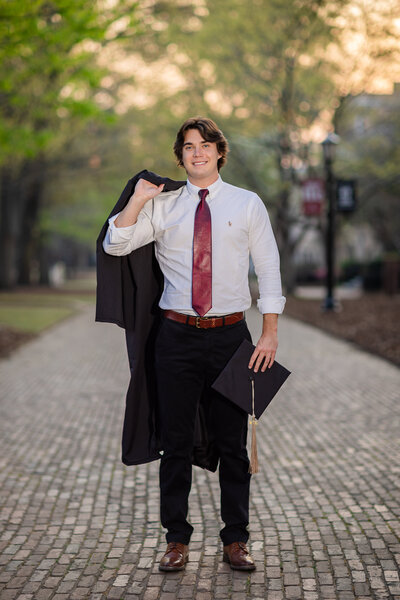 A ​University of South Carolina student taking his senior portrait​s in ​o​n campus at the historic Horseshoe