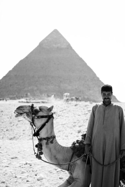 man standing by camel