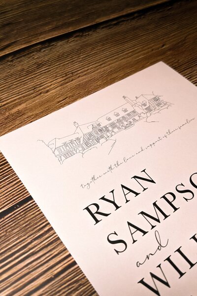 save the date card on a wooden table