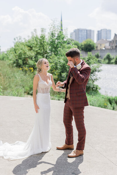 couple smiling and laughing at each other on wedding day