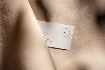 Custom business card design for a cocktail bar and restaurant, incorporating a serene, neutral color scheme.