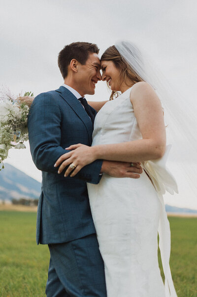 Bride and groom embrace after  their luxury wedding at Sage Lodge in Pray, Montana.