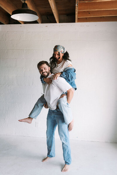 Girl on boyfriend's shoulders in HighLight Studio in Knoxville, Tennessee