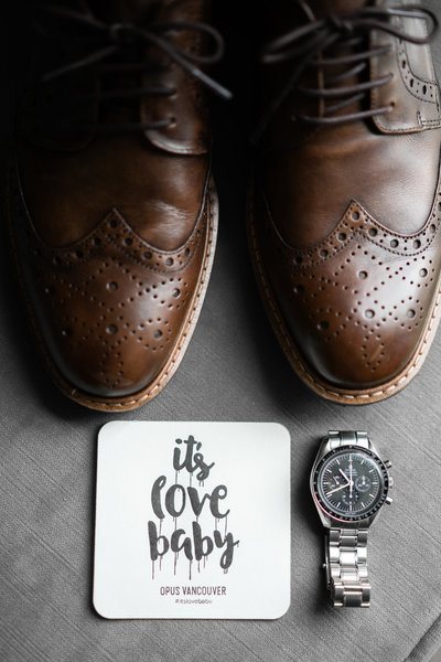 detail photo of grooms shoes, and watch