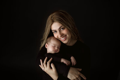 Newborn and Mom in black by a chicago newborn photographer