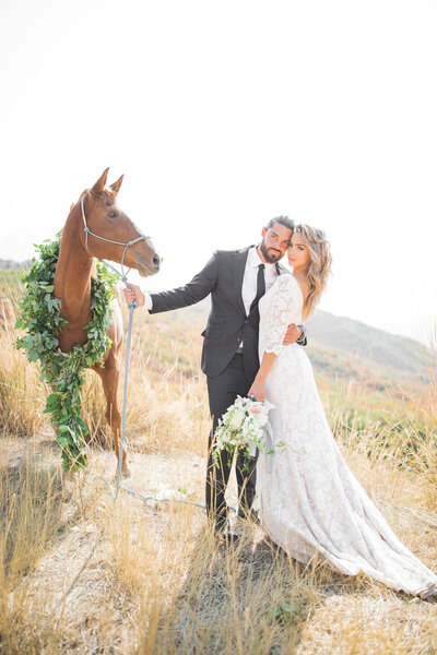 bride and groom with a horse