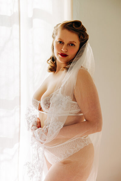 Bridal boudoir image of Missoula woman in white lingerie and wedding veil