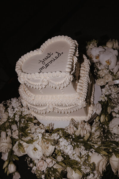 Bride and groom at Calton Hill in Edinburgh sharing a quiet moment beneath the Dugald Stewart Monument during their wedding photoshoot.