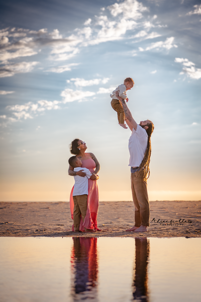 image of family playing on the beach during photo session