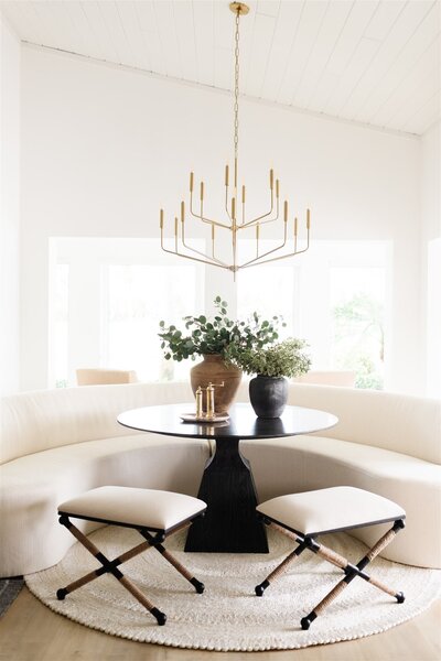 White modern dining room with green plant accents