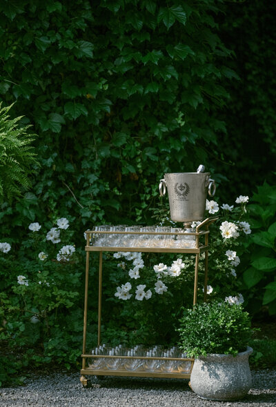 A drink cart decorated with white roses at Greencrest manor