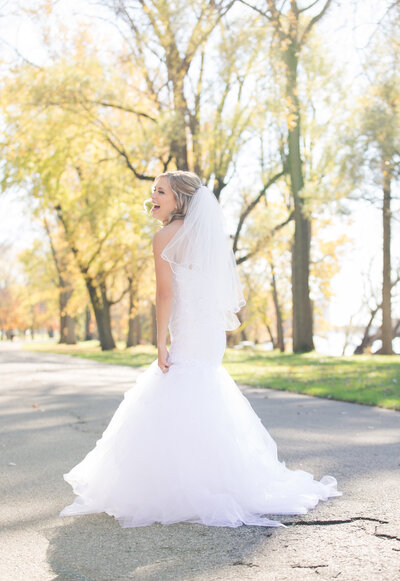 a bride twirling at a park at her wedding in Grand Rapids
