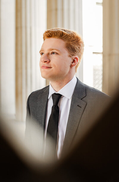 Boy dressed in a suit, gazing away from the camera