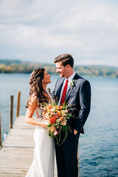 Bride and Groom standing on the dock at The Margate at Lake Winnipesaukee