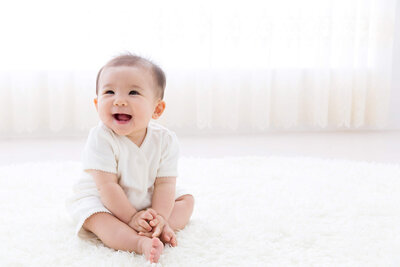 happy baby sitting on floor