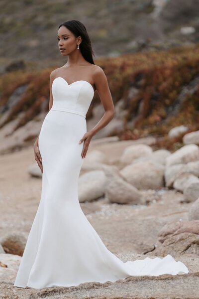 We adore the gorgeous contrast between a demure high neckline and long sleeves paired with a jaw-dropping open back.