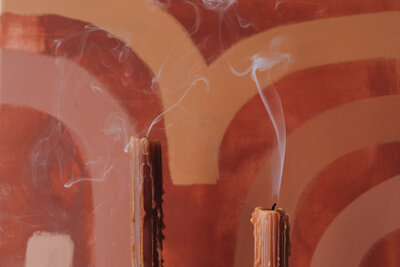 wallpaper behind orange candles blown out 