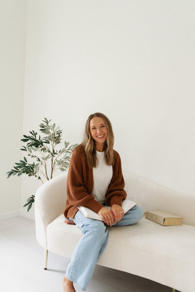 Halle Cherry sits on a white couch beside an iPad displaying a Christian counseling workbook table of contents, representing faith-integrated digital resources for emotional and spiritual healing