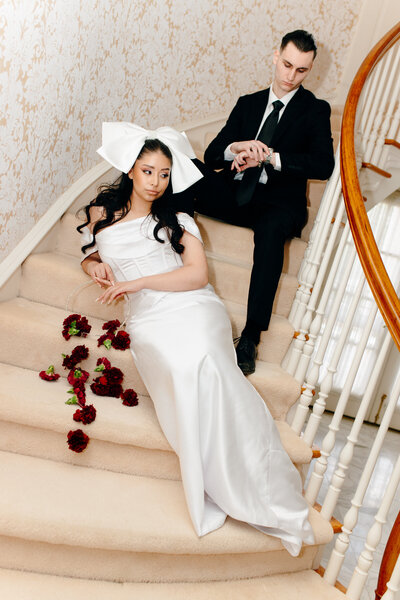 Elegant bride and groom on a staircase.