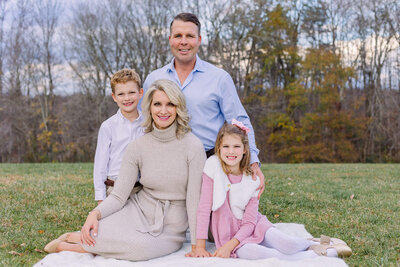 A family of four posing and smiling for Burke family photographer, Melissa Driggers.