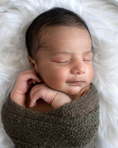 Baby girl wearing a blue headband at her lifestyle newborn photo shoot in Prosper, TX