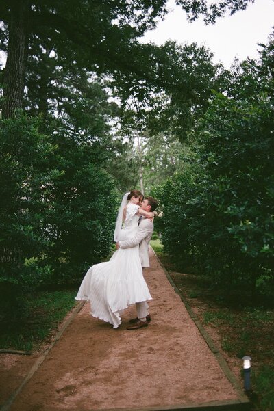 Couple exits the chapel at Lost Mission while being showered with rose petals