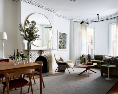 South End brownstone with original plaster molding and modern furniture, blending old and new. Featured by Rue Magazine.
