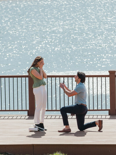 A woman and man at the Montaluce Winery. They are nose to nose with her hand resting on his chest highlighting her new engagement ring.