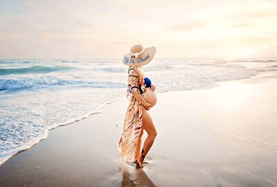 Encinitas maternity photographer Tristan Quigley captures a gorgeous mama on the beach during her maternity photography session showing her pregnant belly
