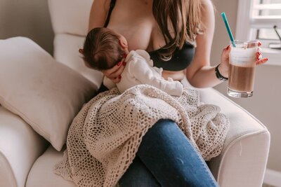 Mom breastfeeding baby during Naperville newborn session 