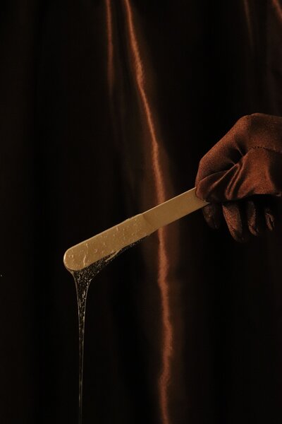 Waxing stick with wax dripping off