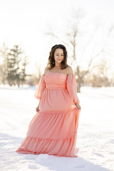 Colorado Springs Portrait photographer woman in pink dress in the snow