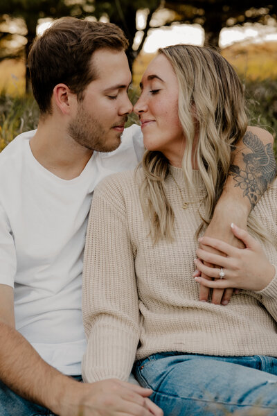 Romantic Omaha engagement session during the fall, captured by Tori Nichole Photography. The couple is surrounded by vibrant autumn foliage and golden light, creating warm, timeless moments. A perfect blend of natural beauty and authentic connection, showcasing the magic of the season and their love story.