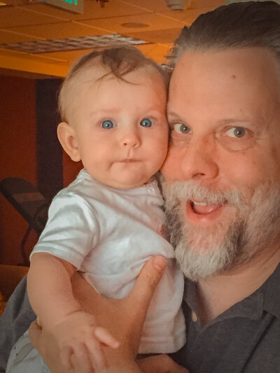 My husband cheesing it up for the camera with one of our granddaughters