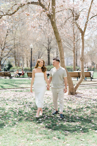 Couple holding hands and walking through Rittenhouse Square