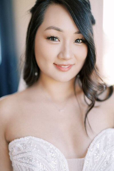 Close-up of bride in soft window light, elegant wedding morning captured by Toronto photographer