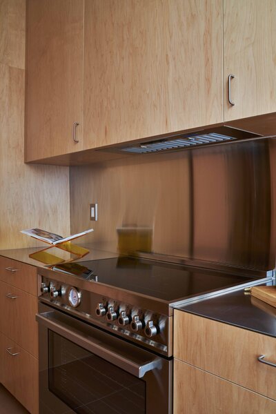 Southern California kitchen remodel galley kitchen renovation modern organic kitchen design Norwegian Rose marble countertop maple plywood kitchen cabinets stainless steel floating shelf porcelain 2x2 mosaic tile Saltillo breeze blocks modern kitchen storage solutions SoCal interior design organic modern kitchen kitchen design with natural light thoughtful floor plan edits custom pullout pantry contemporary galley kitchen