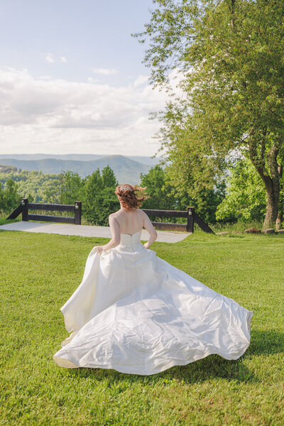 bride runs through the mountains in Roanoke in a wedding dress