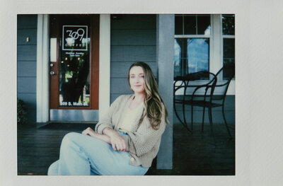Polaroid photo of Britni Dean sitting on a porch