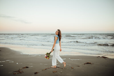 Senior female walks along beach