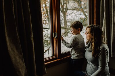 mom with son in front of window