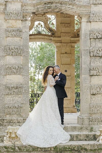 couple embracing in front of stone building