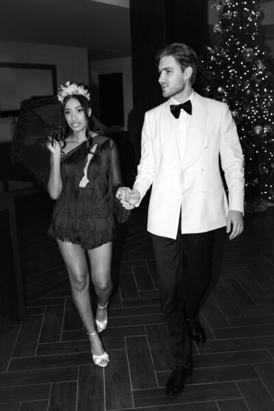 Wedding photographer captures couple taking a stroll hand in hand at their french chateau wedding.