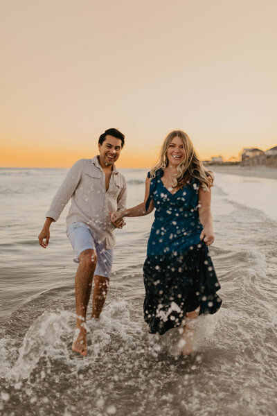 Topsail Beach Couple Engagement Photos On The Beach Running Through Water North Carolina