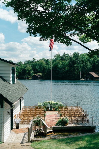 adirondack great camp wedding with the ceremony on the dock overlooking lake placid by julia rebecca photography