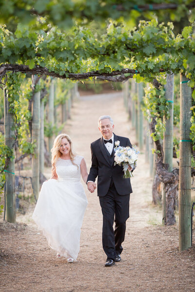 Couple walking through the vineyard at Wilson Creek Winery