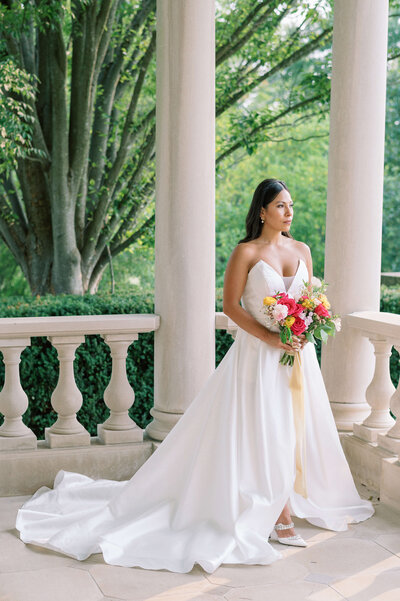 Bride poses with a pink and yellow bouquet during her Washington DC wedding